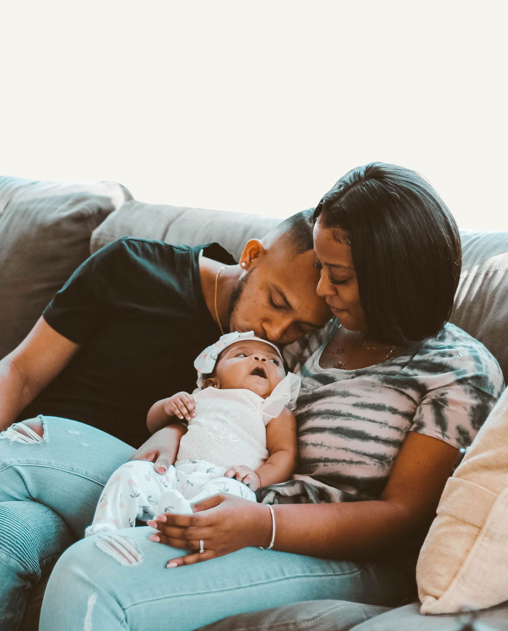 Two parents with their infant child.